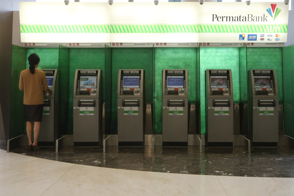 FILE - ATMs in Jakarta.