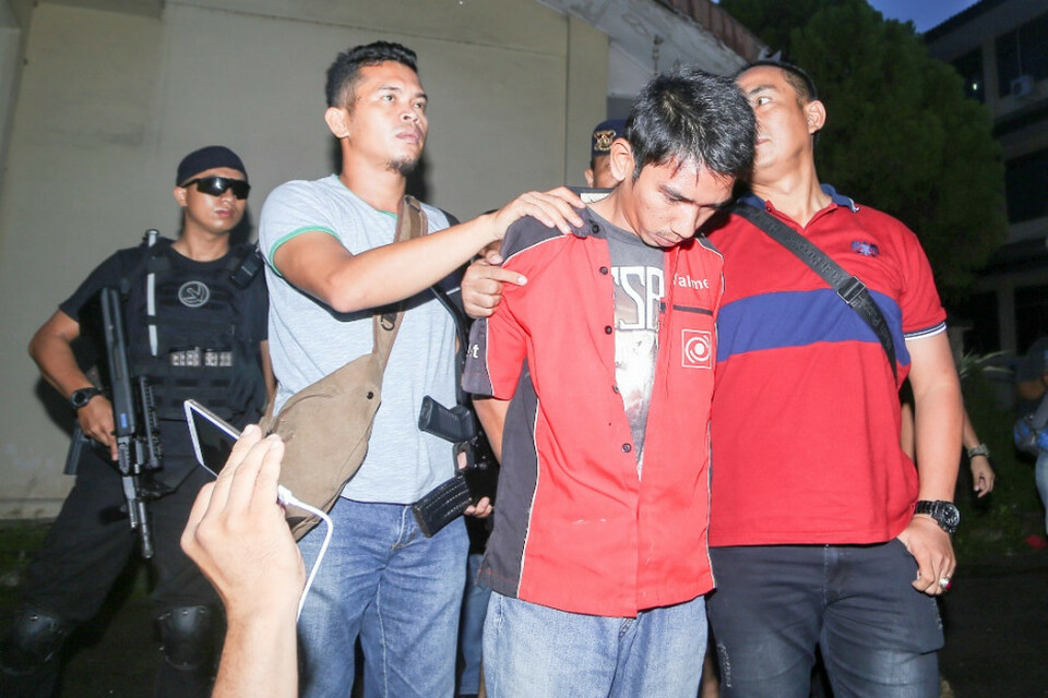 A suspected Islamic State sympathizer is arrested in South Sumatra in July 2017. (Antara Photo)