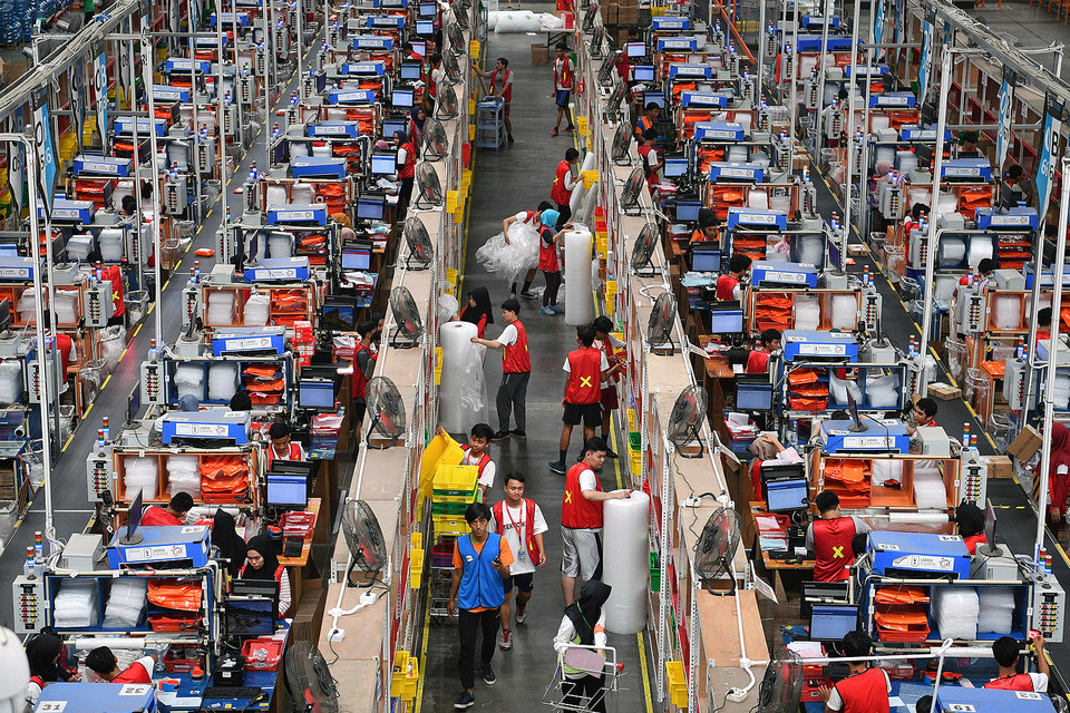 This 2018 file photo shows workers pack merchandise for online sale delivery in a Lazada warehouse in Depok, West Java. (Antara Photo/Sigid Kurniawan)