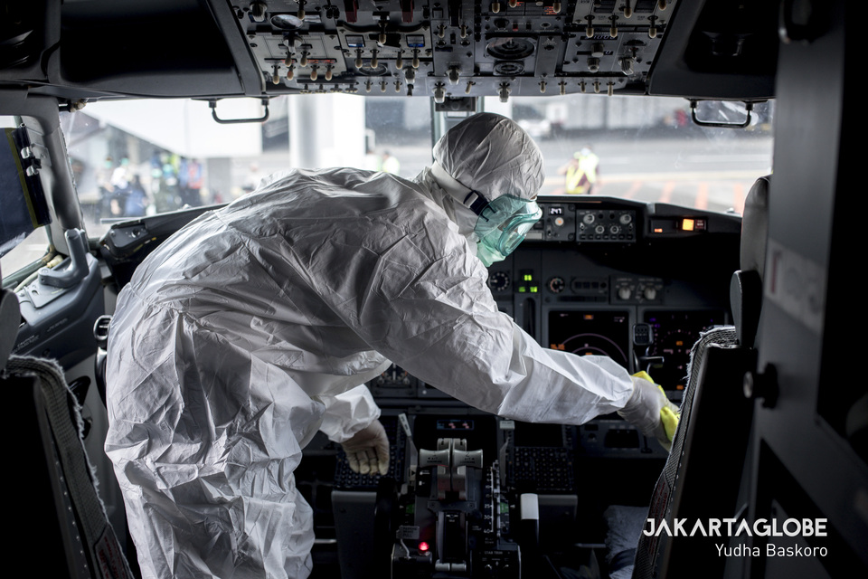 A medical worker cleans a cockpit at the Soekarno-Hatta Airport. (JG Photo/Yudha Baskoro)