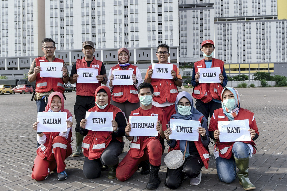 Indonesian Red Cross personnel at the Asian Games Athletes' Village in Kemayoran, Central Jakarta, that has been converted into a makeshift Covid-19 hospital on Saturday. (Antara Photo/M. Risyal Hidayat)