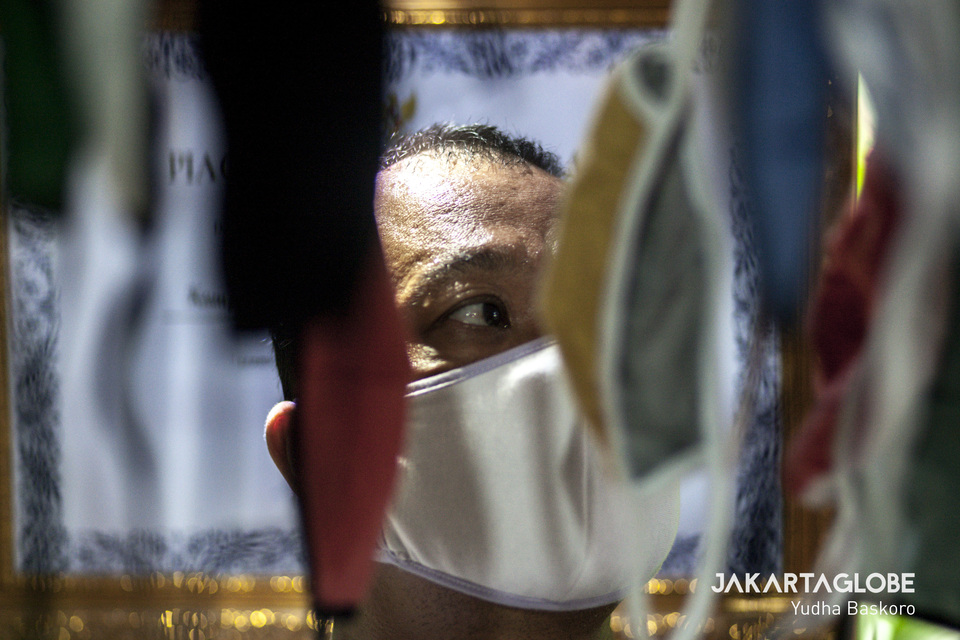A man hangs up face masks to dry at a workshop in Kampung Anggur, Tangerang, Banten, on Thursday. (JG Photo/Yudha Baskoro)
