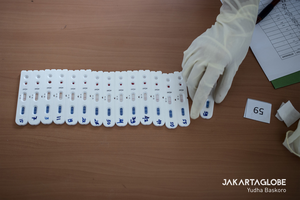 A health worker collects Covid-19 rapid testing strips in Central Jakarta on Monday. (JG Photo/Yudha Baskoro)