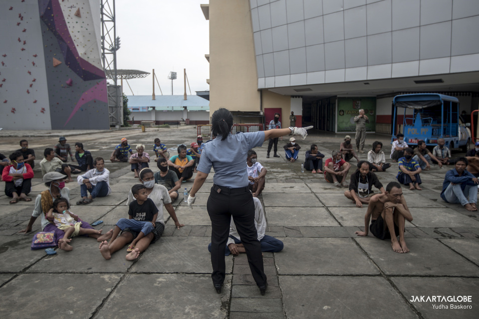 Homeless people housed in the Ciracas Sports Hall in East Jakarta do their morning exercise on May 1. (JG Photo/Yudha Baskoro)
