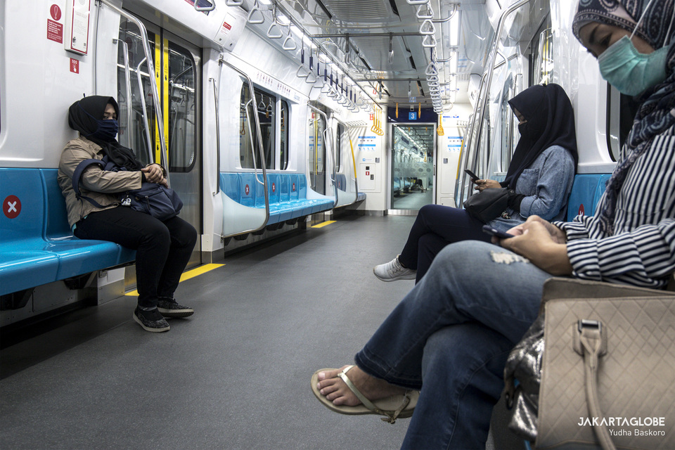 Passengers sit at least two seats apart from each other on the Jakarta MRT train. (JG Photo/Yudha Baskoro)