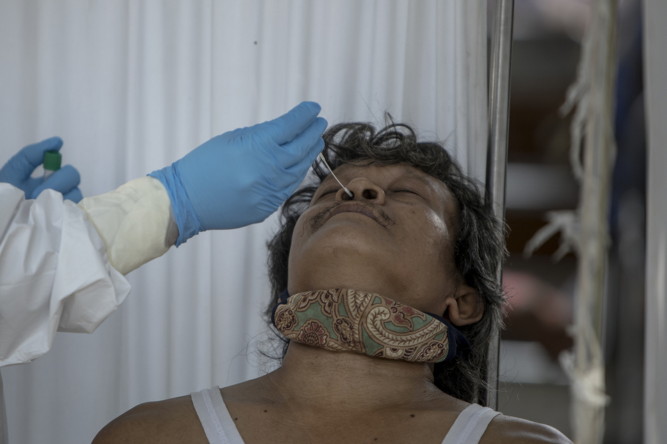 A man takes a swab test for coronavirus in West Jakarta on June 17, 2020. (JG Photo/Yudha Baskoro)