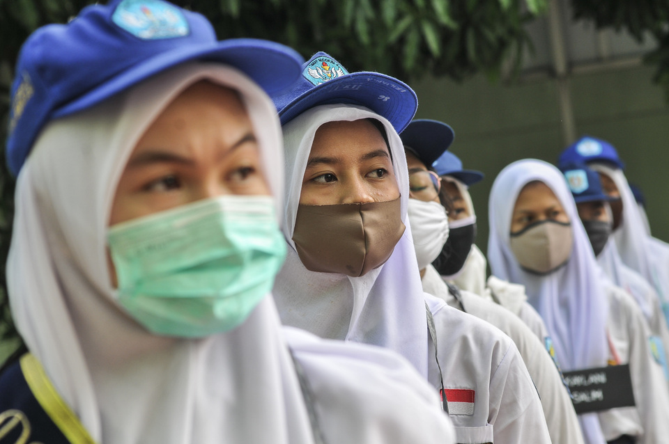 Newly-enrolled students of State High School 2 in Bekasi, West Java, attend a flag ceremony on July 13, 2020. Participants are limited to 48 of 384 new students to follow the health protocols during the Covid-19 pandemic. (Antara Photo/Fakhri Hermansyah)