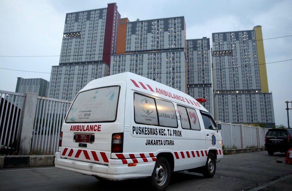 An ambulance owned by the North Jakarta Municipal Government enters the athletes’ village in Kemayoran, Central Jakarta, on Sept. 11, 2020. The building functions as a makeshift hospital and isolation facilities for Covid-19 patients. (Beritasatu Photo/Joanito De Saojoao)