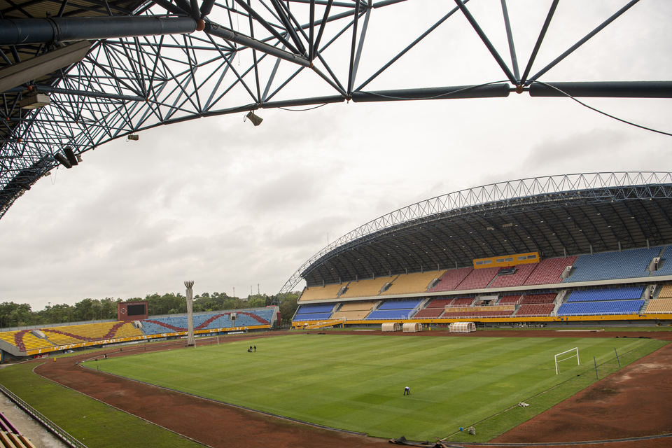 Lawn care workers are seen at the Gelora Sriwijaya Jakabaring Stadium in Palembang, South Sumatra, on Sept. 21, 2020. The stadium is being prepared for the FIFA U-20 World Cup in May-June next year. (Antara Photo/Nova Wahyudi)