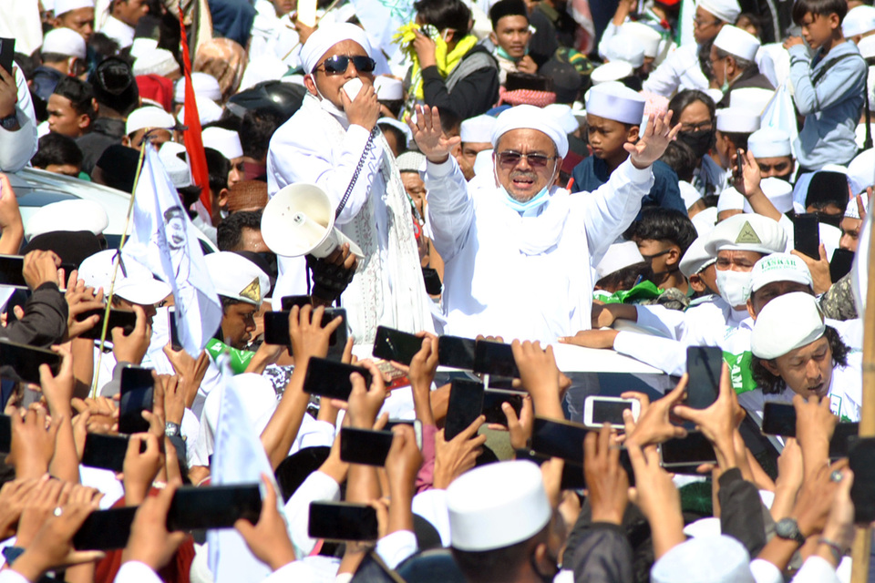 Rizieq Shihab, the leader of the Islamic Defender Front (FPI), greets his followers in Puncak, Bogor district in West Java on Friday. (Antara Photo/Arif Firmansyah)