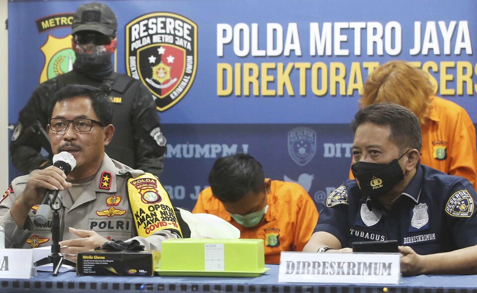 Jakarta Police Chief Insp. Gen. Nana Sudjana, left, speaks in a press conference in Jakarta on Sept. 17, 2020.(Beritasatu Photo/Joanito De Saojoao)
