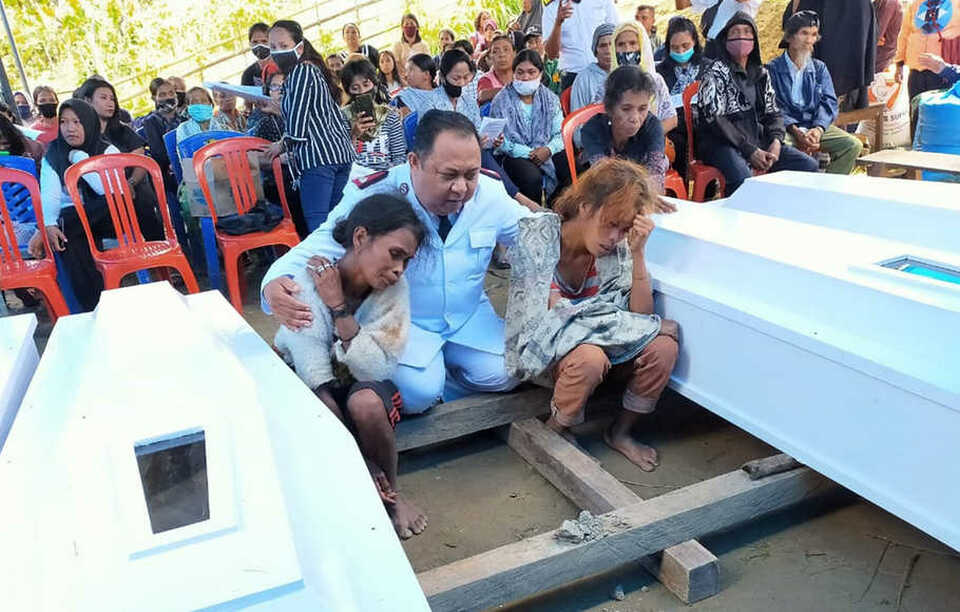 Erik A. Kape, The Salvation Army's commander for Palu, center, consoles the East Indonesia Mujahidin attack victims' widows during a funeral ceremony in Sigi, Central Sulawesi on Saturday. (B1 Photo)