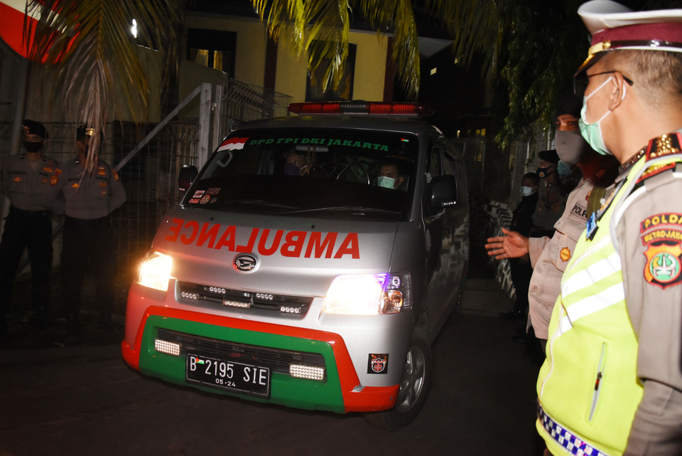 An ambulance carrying the body of a slain FPI member leaves the Kramat Jati Police Hospital in East Jakarta on Dec. 8, 2020. (Antara Photo/Indrianto Eko Suwarso)