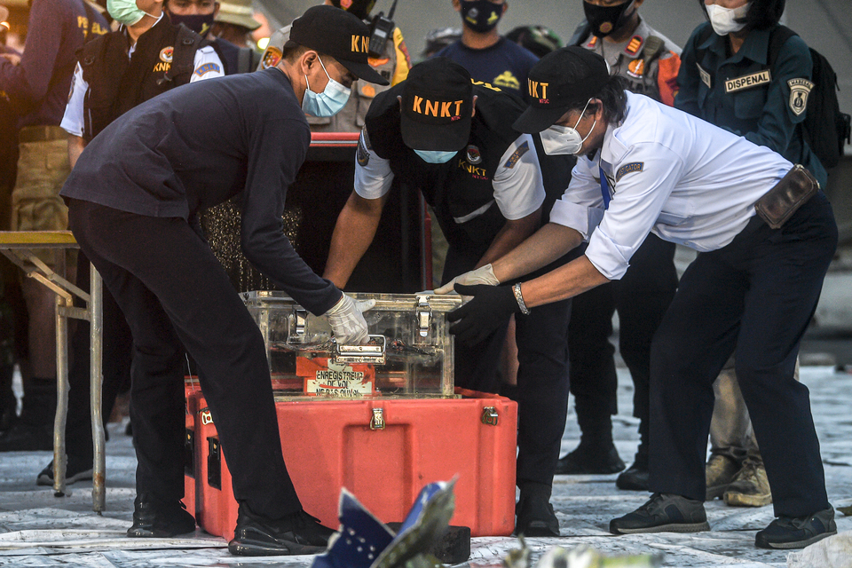 Indonesian authorities inspect the black box of ill-fated Sriwijaya Air plane retrieved from the seabed north of Jakarta on Jan. 12, 2021.  (Antara Photo/Muhammad Adimaja)