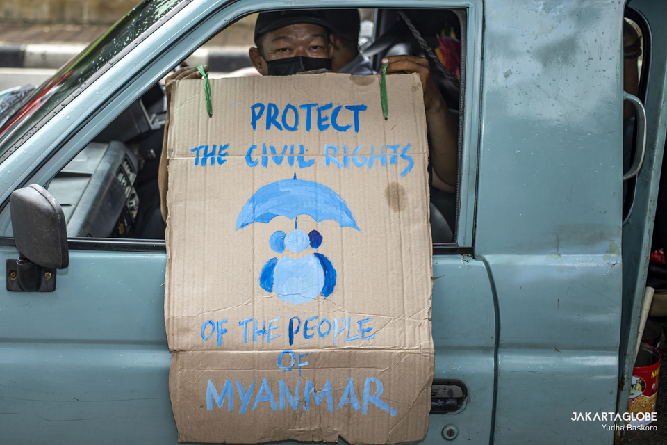 A protester carries a placard during a protest on Myanmar crisis in front of the Myanmar Embassy in Central Jakarta on Feb. 5, 2021. (JG Photo/Yudha Baskoro)