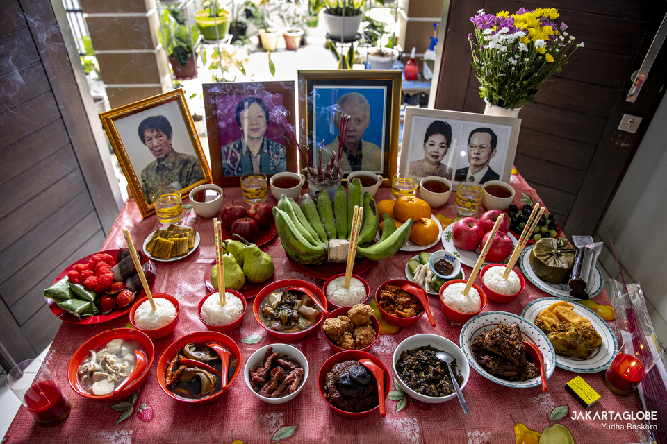 Portraits of Sugi Trisna family ancestors are seen on a worship table during the Chinese Lunar New Year tradition at South Tangerang, Banten, on Feb 11, 2021. (JG Photo/Yudha Baskoro)