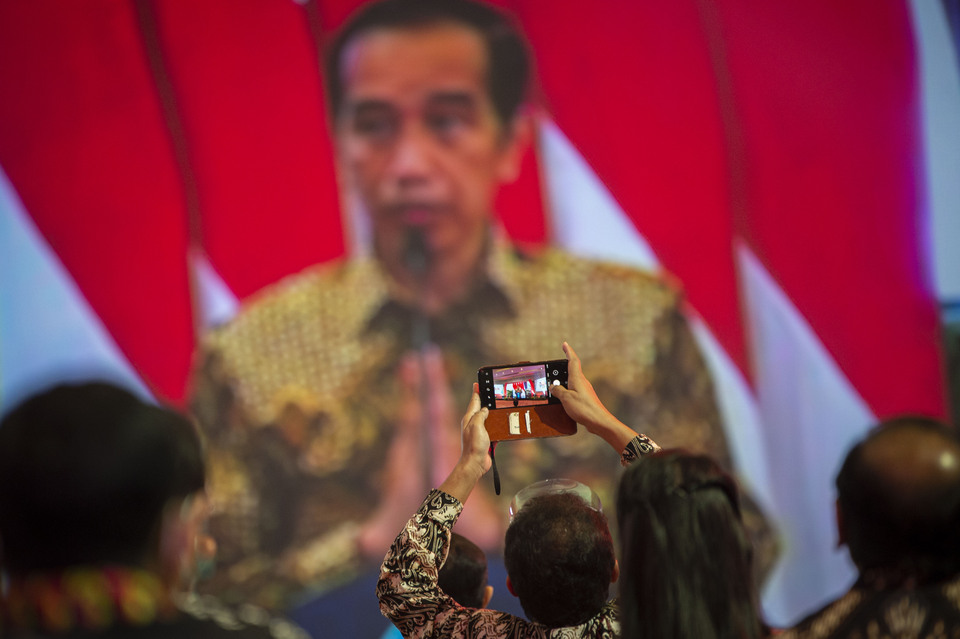 A man tries to capture President Joko "Jokowi" Widodo