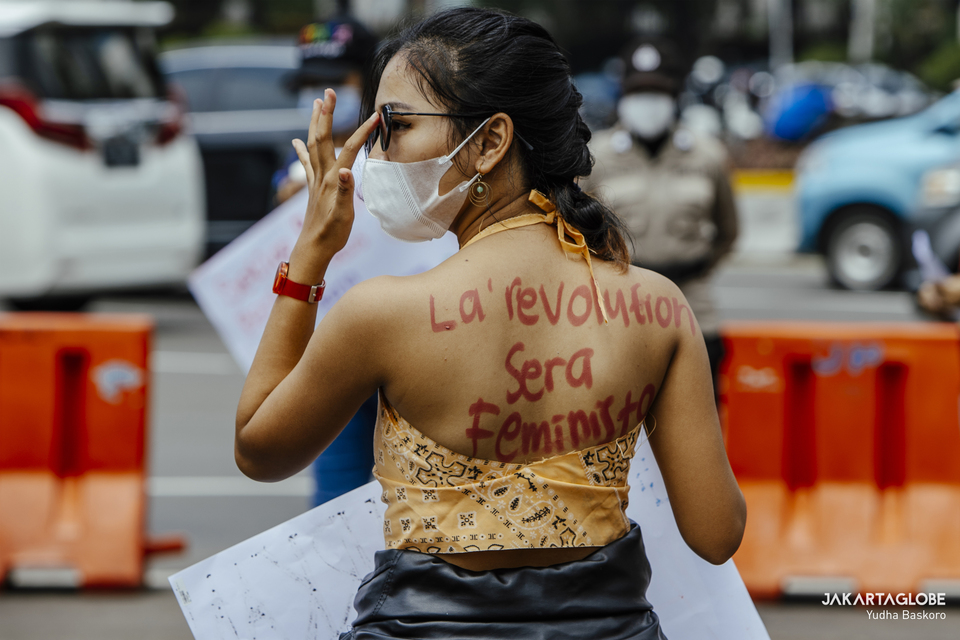 A woman shows a message written on her back during International Women's Day rally in Central Jakarta on March 8, 2021. (JG Photo/Yudha Baskoro)