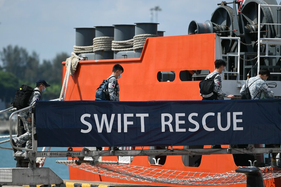 In this photo posted by Singaporean Defense Minister Ng Eng Hen, Navy personnel embark submarine rescue vessel MV Swift Rescue for a mission to help locate a missing Indonesian submarine on April 21, 2021.