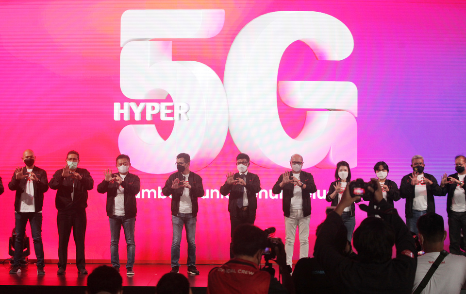 Minister of Communication and Information Technology Jhonny G. Plate, center, and Setyanto Hantoro, Telkomsel's president director, fourth from right, and members of Telkomsel's boards pose for photographs during a 5G launch event in Jakarta on May 27, 2021. (Antara Photo/Reno Esnir)