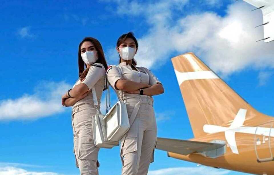 This undated photo shows Super Air Jet's stewardesses pose for photographs with an A320 aircraft sporting the airline livery. (Photo courtesy of Super Air Jet)