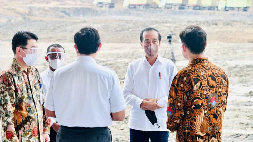 President Joko "Jokowi" Widodo, center, converses with several people on the sidelines of HKML Indonesia