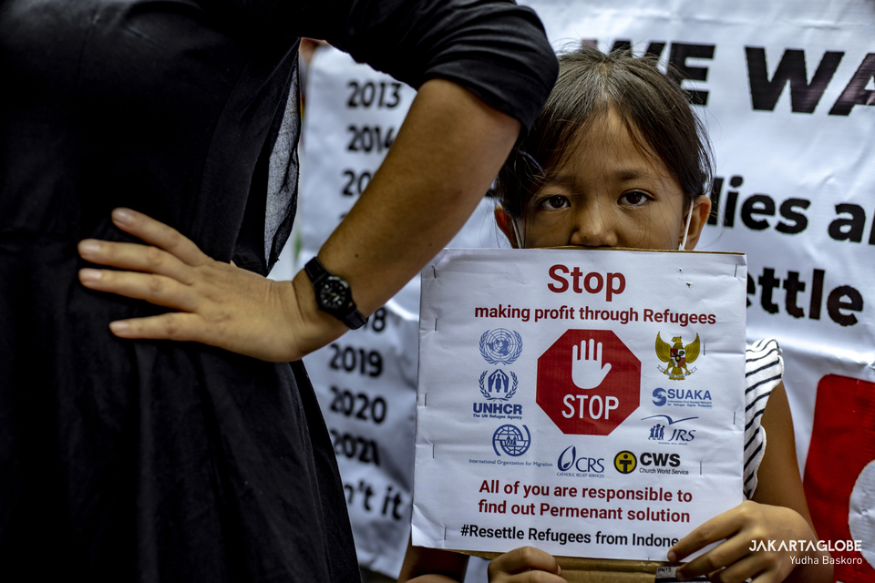 A refugee carries a placard during protest in front of UNHCR building in Central Jakarta on November 15, 2021. (JG Photo/Yudha Baskoro)
