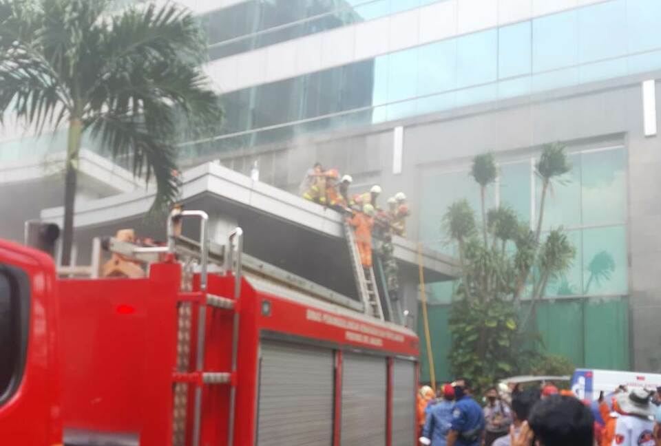 Fire workers rescue victims from fire in the Cyber Building in South Jakarta, Dec. 2, 2021. (Photo courtesy of the Jakarta Fire Department)