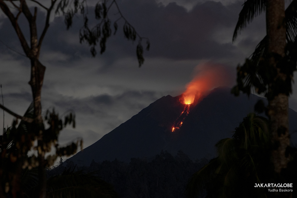 A photograph taken from Sumberwaluh Village in Lumajang, East Java shows Mount Semeru spewing lava and hot ash on December 6, 2021. (JG Photo/Yudha Baskoro)