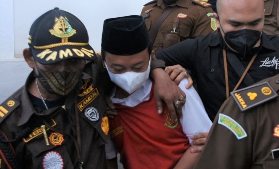 Handout photo: Suspected serial child rapist Herry Wirawan, center, is escorted by prosecutors at the Bandung District Court in West Java, January 11, 2022.