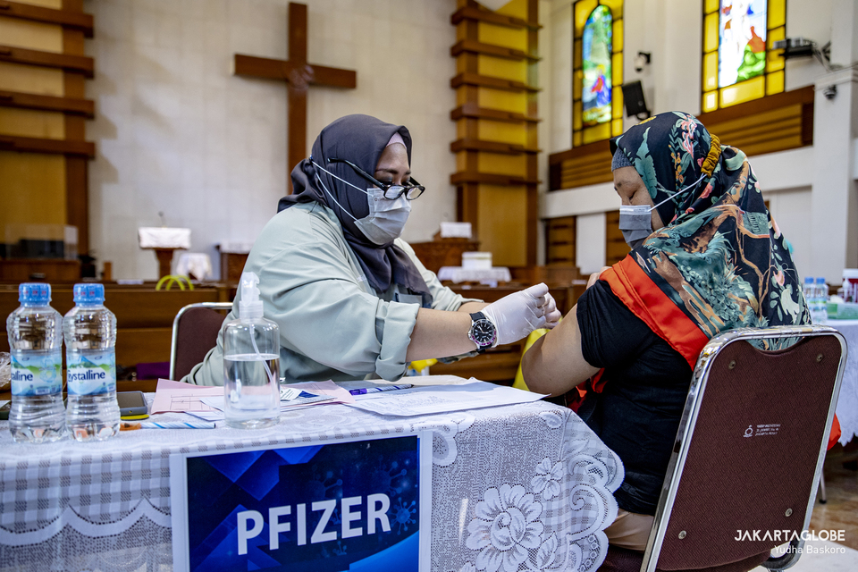 A Muslim woman receives her booster dose of vaccine against Covid-19 at a Batak Christian Protestant Church or HKBP in Menteng, Central Jakarta, on February 3, 2022. (JG Photo/Yudha Baskoro)