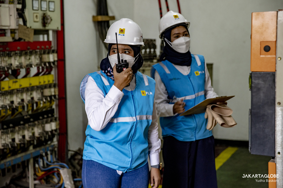 Two state-owned electricity company PLN female technicians inspect equipment at the company's branch office on Jalan MH Thamrin, Central Jakarta on April 20, 2022. (JG Photo)