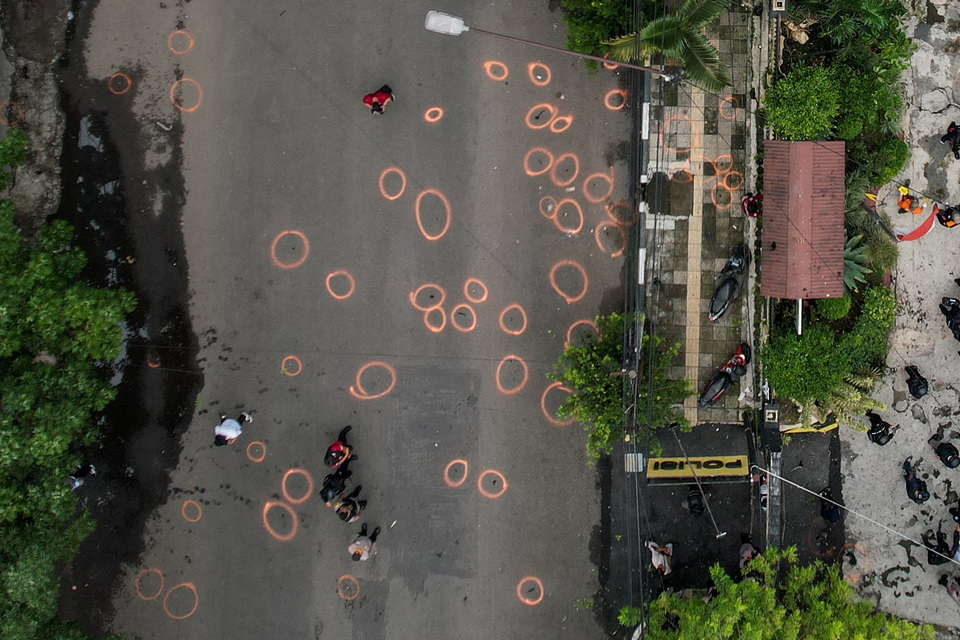 The aerial photo shows police officers conducting the crime scene investigation in front of Astana Anyar police station in Bandung, West Java, shortly after a suicide bombing that kills a policeman on December 7, 2022. (Antara Photo/Raisan Al Farisi)