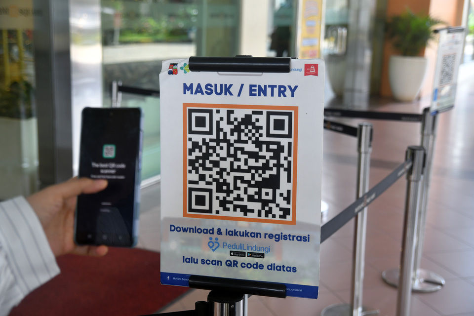A visitor scans the PeduliLindungi barcode before entering the Botani Square Mall in Bogor on Jan. 4, 2023. (Antara Photo/Arif Firmansyah)