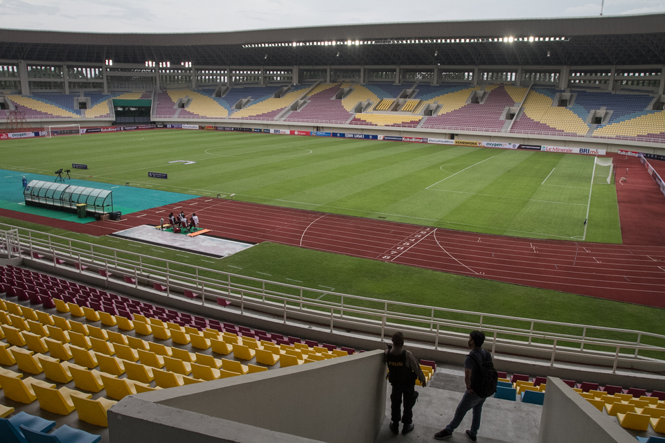 Two men stand on the seating rows of Manahan Football Stadium on December 5, 2022. The stadium in the Central Java town of Solo is proposed to host matches of the U20 World Cup starting on May 20, 2023. (Antara photo)