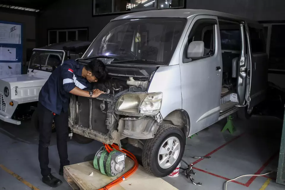 A technician works on converting a convetional car into an electric vehicle (EV) in Lengkong, South Tangerang on Feb. 3, 2023. (Antara Photo/Rivan Awal Lingga)