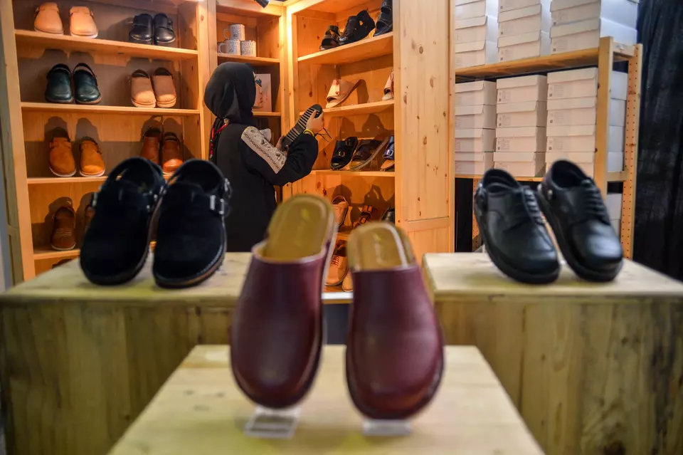 A woman browses the footwear displayed at a festival in Bandung on Jan. 29, 2023. The Indonesian footwear and apparel industry considers the conclusion of EU-Indonesia CEPA as crucial for job creation and investments in Indonesia. (Antara Photo/Raisan Al Farisi)