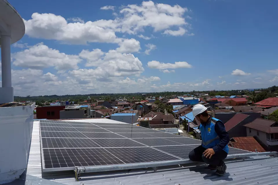 A technician inspects the solar panel on the rooftop of the Al Islah mosque in Sorong, Papua, on Feb. 23, 2023. (Antara Photo/Olha Mulalinda)