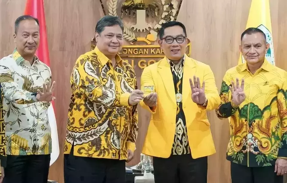 West Java Governor Ridwan Kamil, second right, receives a membership card from Golkar Party Chairman Airlangga Hartarto, second left, after he formally joins the political party in Jakarta on January 18, 2023. (Beritasatu/ Yustinus Paat)