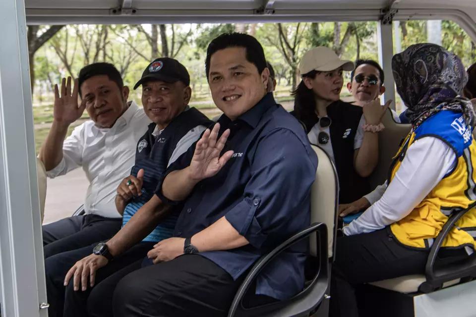 State-Owned Enterprise Minister Erick Thohir (third from the left) waves to the camera after inspecting the football pitch for 2023 U-20 World Cup practice at the Jakabaring Sport City on March 1, 2023. (Antara Photo/Nova Wahyudi)