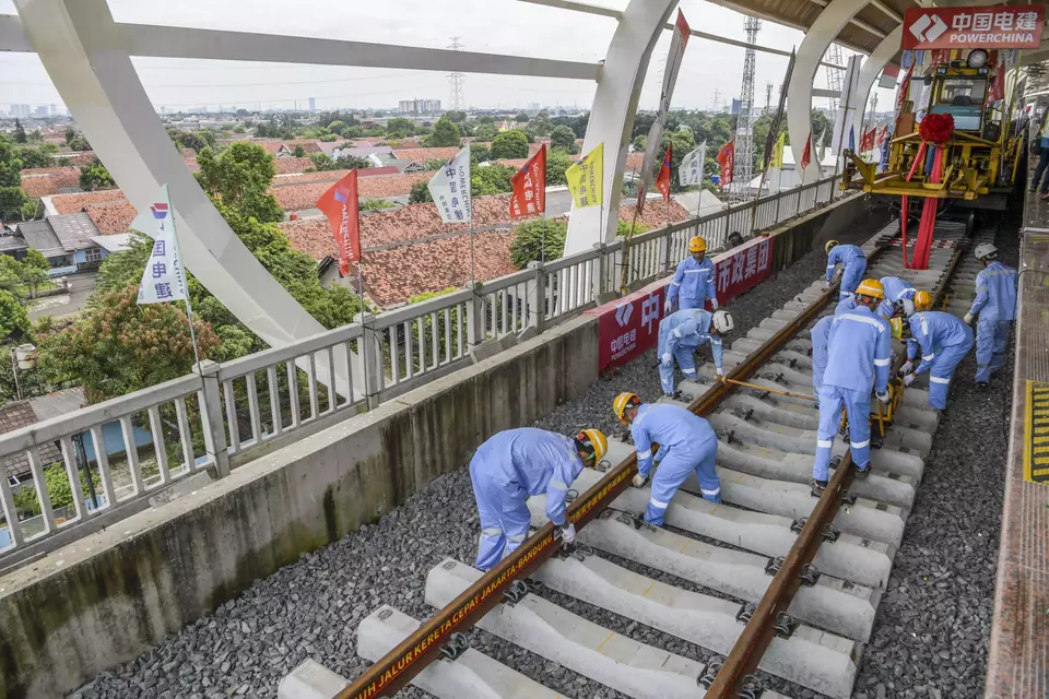 Workers install the rails of the Jakarta-Bandung high speed railway project in Halim Station, East Jakarta, on March 31, 2023. (Antara Photo/Galih Pradipta)
