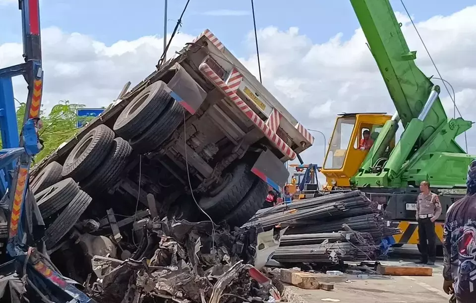 A heavy machine pulls a truck carrying steel iron bars after chain-reaction crashes on a toll road in Boyolali, Central Java, that killed at least eight people on April 14, 2023. (B-Universe Photo/Hanes Walda)