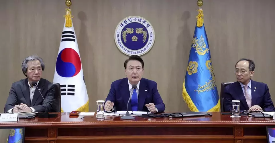 South Korean President Yoon Suk Yeol, center, speaks during a meeting of the Central Disaster and Safety Countermeasures Headquarters about measures to deal with the coronavirus pandemic at the presidential office in Seoul, South Korea, Thursday, May 11, 2023. (Yonhap via AP)