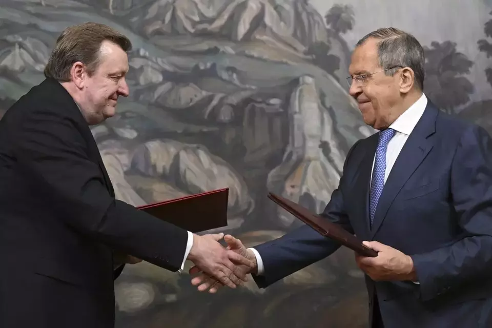 Russian Foreign Minister Sergey Lavrov, right, and Belarusian Foreign Minister Sergei Aleinik exchange documents prior to a joint news conference following their talks in Moscow, Russia, Wednesday, May 17, 2023. (Natalia Kolesnikova/Pool Photo via AP)