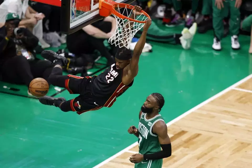 Miami Heat forward Jimmy Butler, left, dunks as Boston Celtics guard Jaylen Brown defends during the second half in Game 7 of the NBA basketball Eastern Conference finals Monday, May 29, 2023, in Boston. (AP Photo/Michael Dwyer)