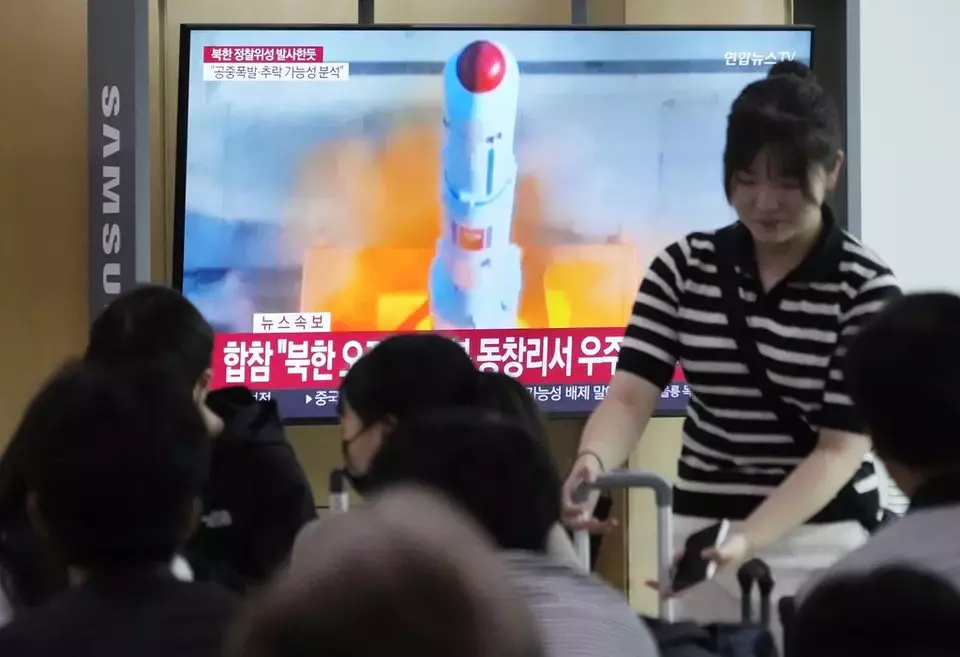 A TV screen shows a file image of North Korea's rocket launch during a news program at the Seoul Railway Station in Seoul, South Korea, Wednesday, May 31, 2023. North Korea launched a purported rocket Wednesday, a day after the country announced a plan to put its first military spy satellite into orbit, South Korea's military said. (AP Photo/Ahn Young-joon)