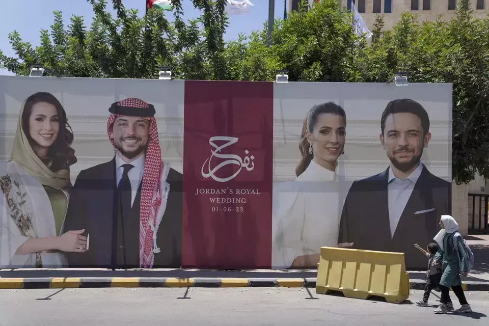 A poster with pictures of Crown Prince Hussein and his fiancee, Saudi architect Rajwa Alseif is posted on a road in Amman, Jordan, Wednesday, May 31, 2023. Crown Prince Hussein and Saudi architect Rajwa Alseif are to be married on Thursday at a palace wedding in Jordan, a Western-allied monarchy that has been a bastion of stability for decades as Middle East turmoil has lapped at its borders.(AP Photo/Nasser Nasser)