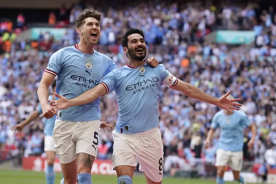 Ilkay Gundogan, right, celebrates after scoring the second goal for Manchester City during the English FA Cup final soccer match versus Manchester United at Wembley Stadium in London, Saturday, June 3, 2023. (AP Photo/Dave Thompson)