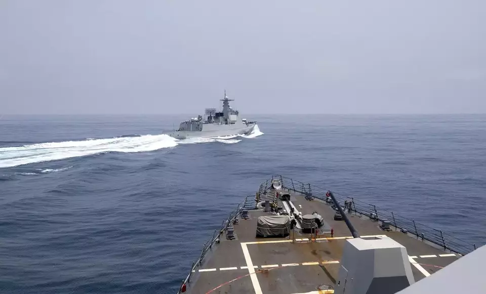 In this photo provided by the U.S. Navy, the USS Chung-Hoon observes a Chinese navy ship conduct what it called an "unsafe" Chinese maneuver in the Taiwan Strait, Saturday, June 3, 2023, in which the Chinese navy ship cut sharply across the path of the American destroyer, forcing the U.S. ship to slow to avoid a collision. (Mass Communication Specialist 1st Class Andre T. Richard/U.S. Navy via AP)