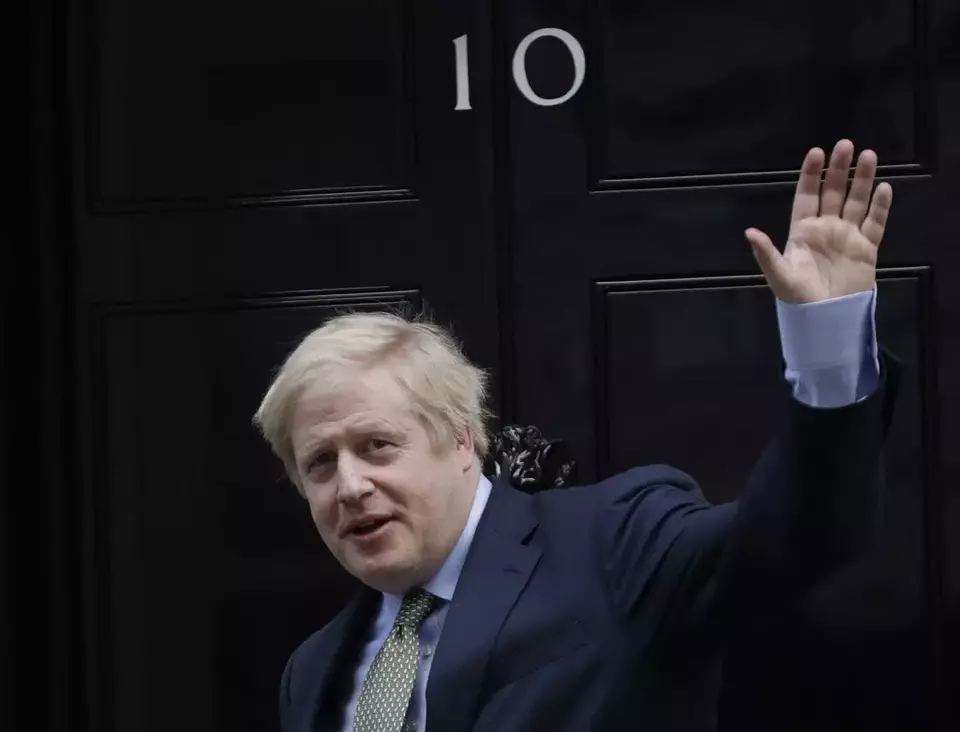 Prime Minister Boris Johnson returns to 10 Downing Street after meeting with Queen Elizabeth II at Buckingham Palace, London, on Friday, Dec. 13, 2019. (AP Photo/Matt Dunham, File)